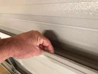 Garage door panel lip provides a way to mount foam insulation panels