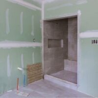 Building code requirements for using green board drywall.
