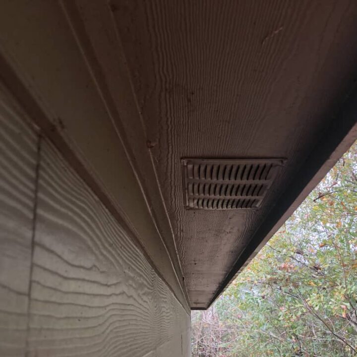 Wooden soffit with ventilation holes.