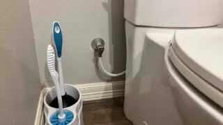 Hide plumbing behind toilet.